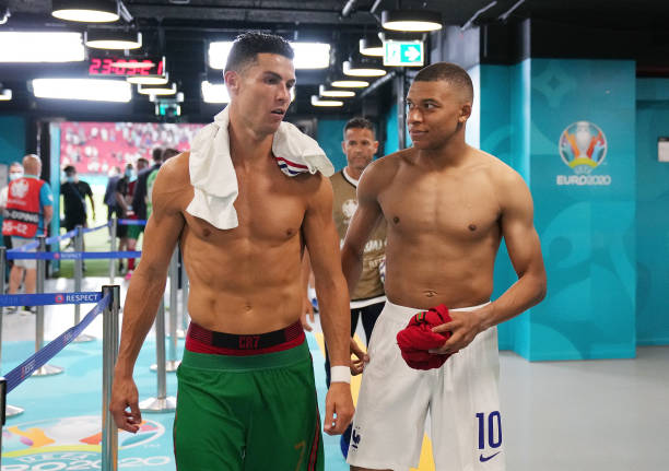 Cristiano Ronaldo of Portugal speaks with Kylian Mbappe of France